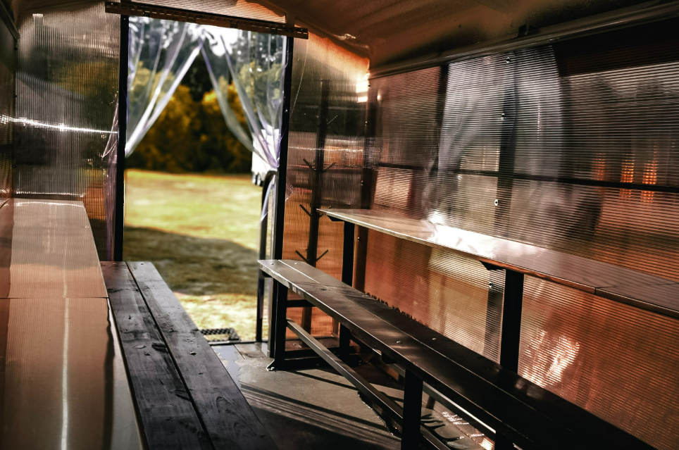 Wide interior view of an Anvil Rentals trailer looking out the open entry toward the jobsite